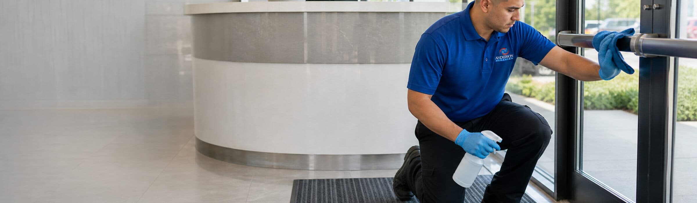 Commercial cleaner wiping a modern reception counter